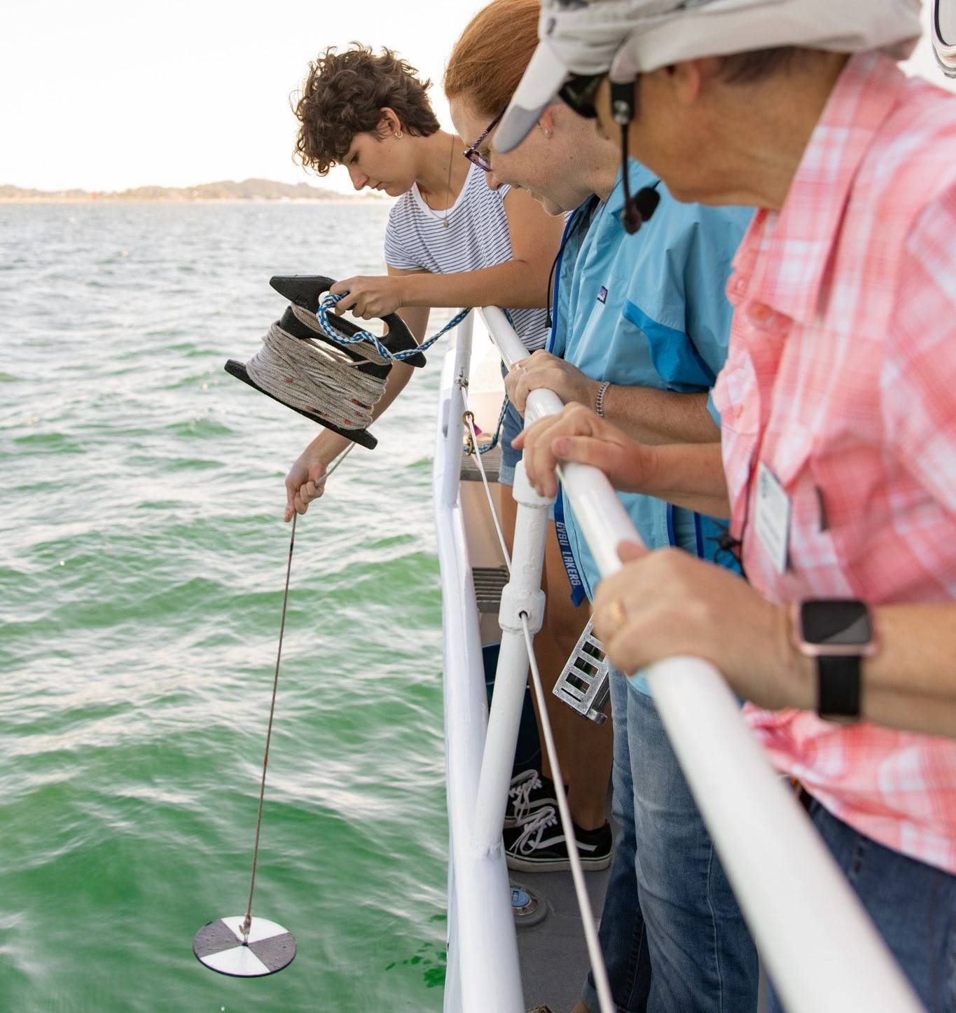 STudents conducting research on GVSU AWRI DJ Angus boat